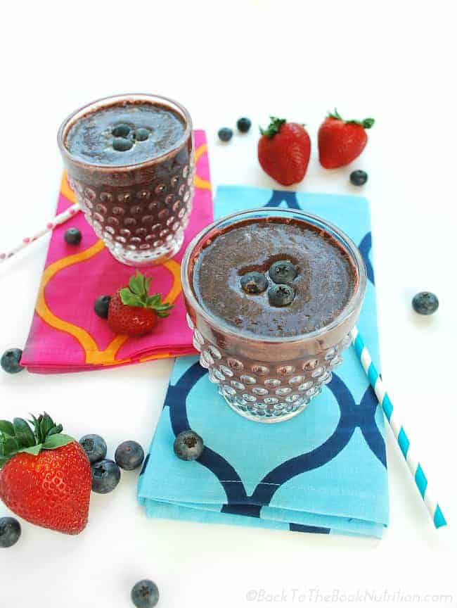 Fight colds and flu naturally with this supercharged immune booster green smoothie made with spinach, frozen strawberries, blueberries, raspberries, cherries, and my homemade elderberry syrup! | Back To The Book Nutrition