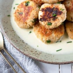 pile of easy crab cakes with butter wine sauce on plate
