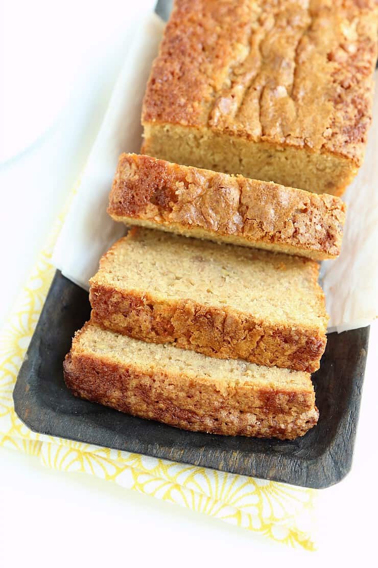 loaf of banana bread sliced on serving tray