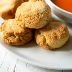 almond flour cheddar biscuits on plate with bowl of tomato soup