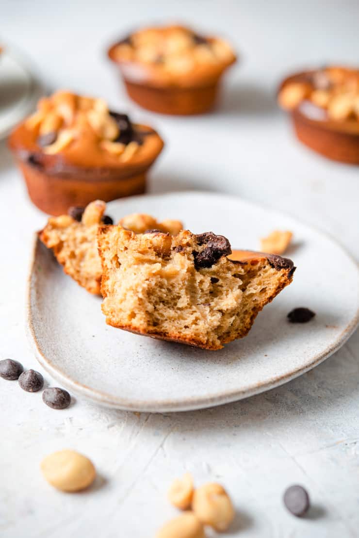 A close up of a healthy chocolate chip muffin cut in half on a plate