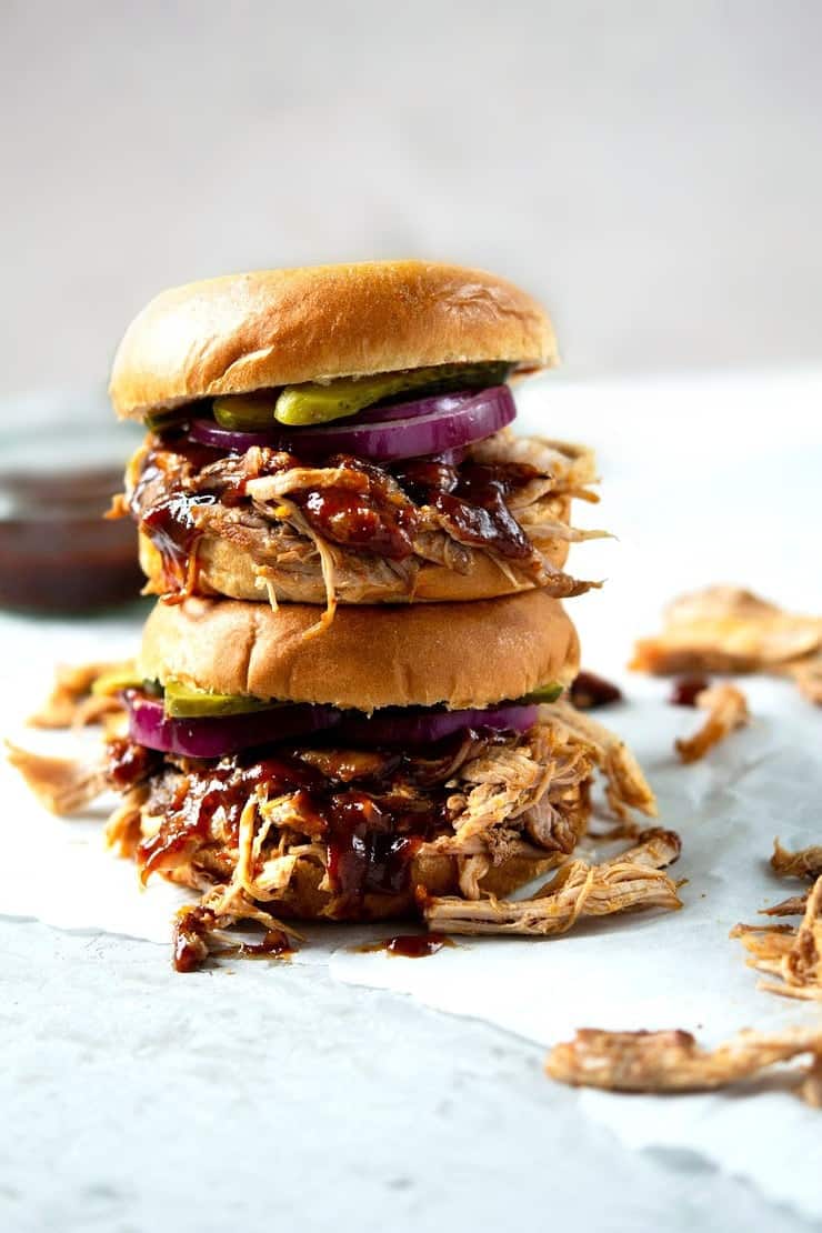 Two pulled pork sandwiches stacked on top of each other