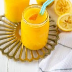 two glasses of fresh mango lemonade with straws