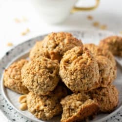 A white plate with a pile of peanut butter oatmeal breakfast cookies