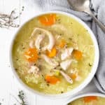 An overhead shot of rotisserie chicken and rice soup in a bowl