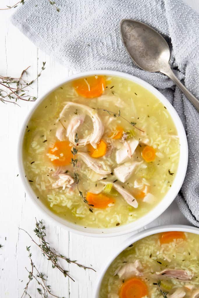 An overhead shot of rotisserie chicken and rice soup in a bowl