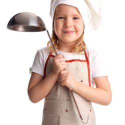 young child with cooking apron and soup ladle