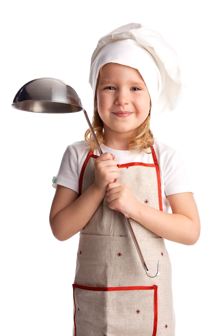 young child with cooking apron and soup ladle