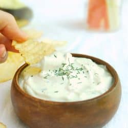 close up image of dipping potato chip into bowl of 5 minute ranch dip