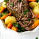 overhead shot of slow cooker beef roast with carrots and potatoes