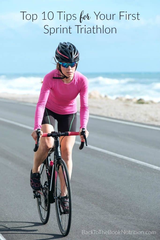 woman cyclist riding a bike on the road close to sea