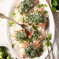 An overhead shot of baked salmon with parmesan crust on a serving plate