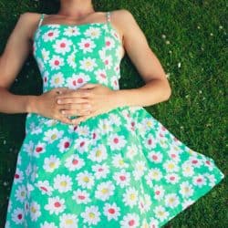 woman in flowered dress lying on grass