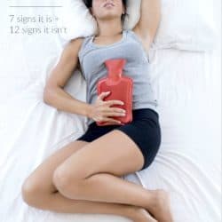 woman lying in bed with hot water bottle on stomach