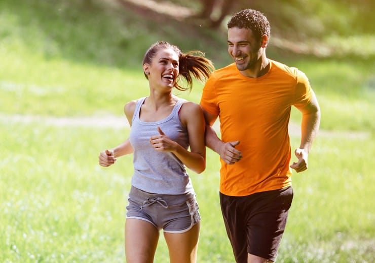 Couple jogging and running outdoors in nature