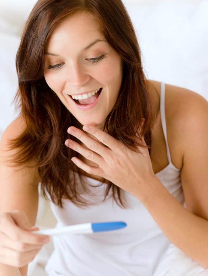 woman excited about positive pregnancy test