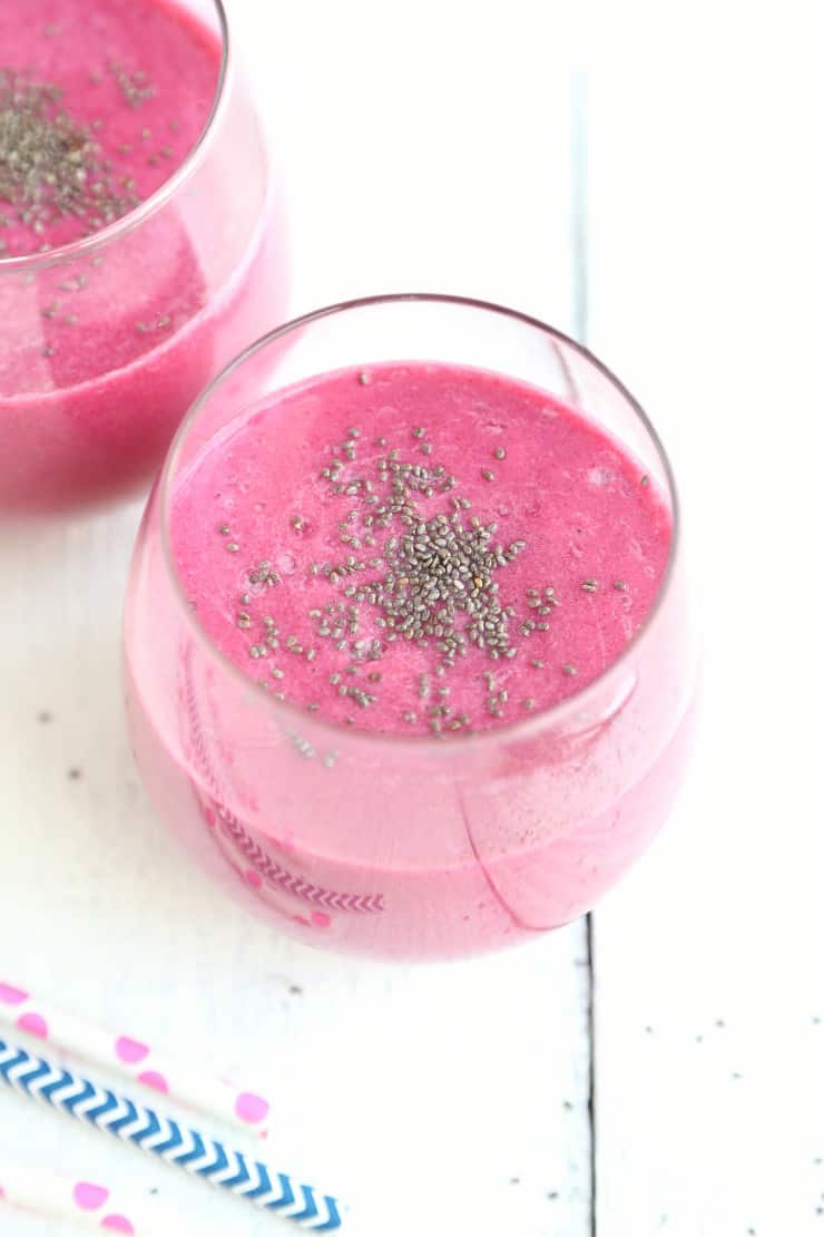 Close up view of 2 glasses creamy strawberry beet smoothie with chia seeds on top