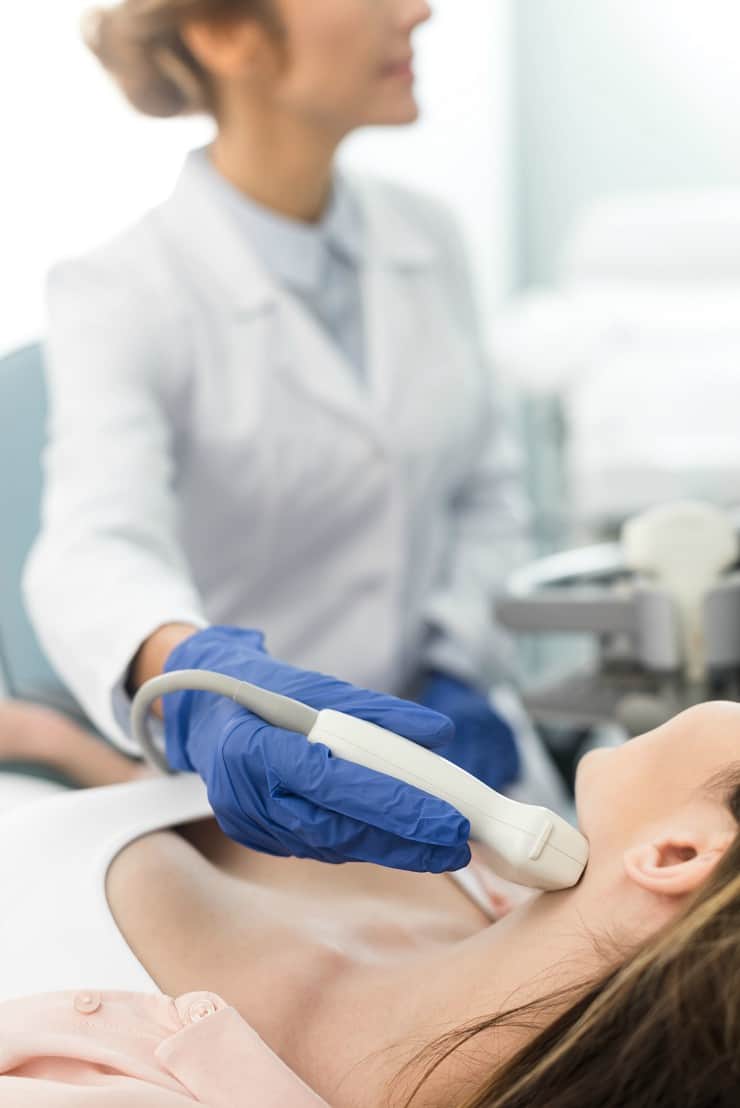 image of close up image of woman having thyroid ultrasound