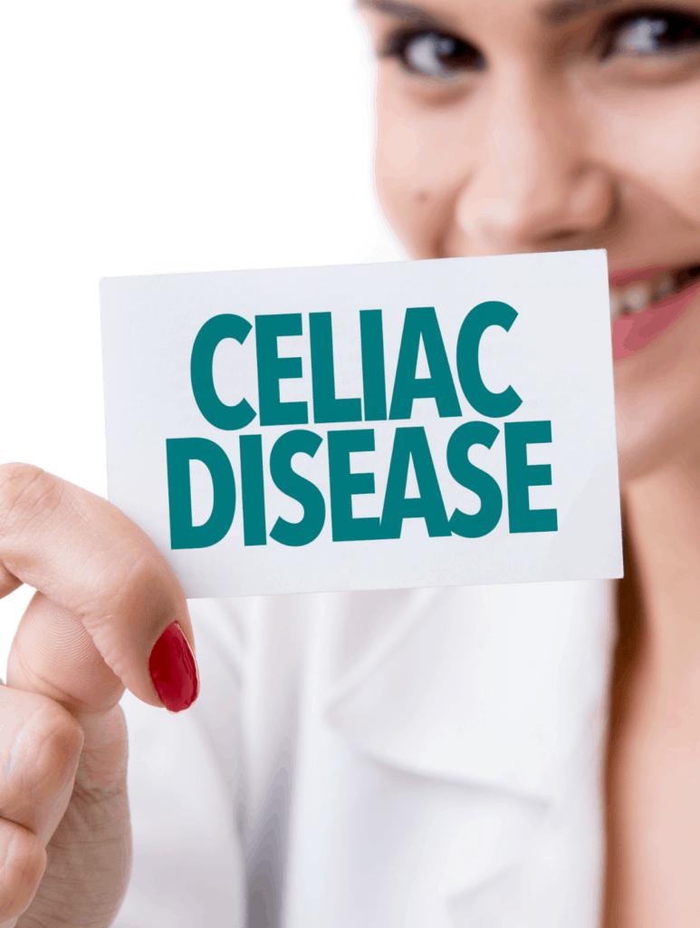 smiling female doctor in lab coat holding Celiac Disease sign