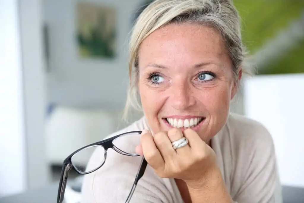 40 something blonde woman smiling at desk